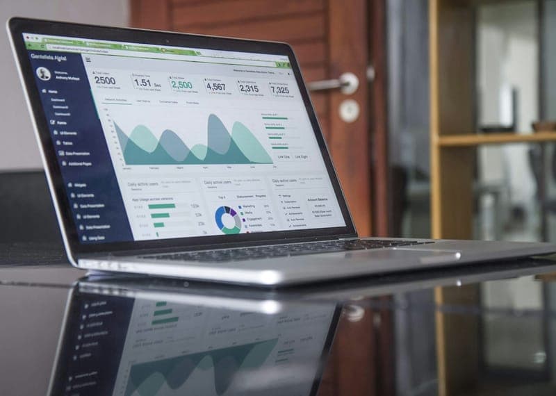 A laptop displaying data charts and graphs — representing the Unified Analytics Platform's data analysis product.